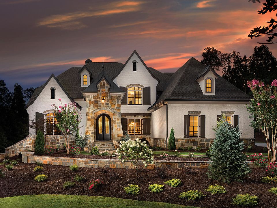 Elegant painted brick and stone French Country exterior