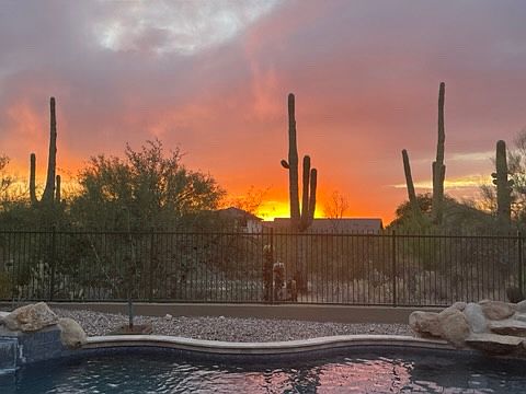 sunset over backyard pool