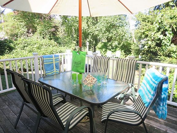 Outdoor living with umbrella for shade and gas grill for eas