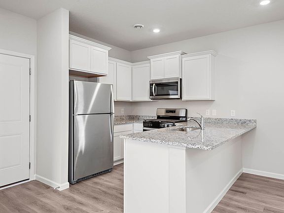 The kitchen has stainless steel appliances