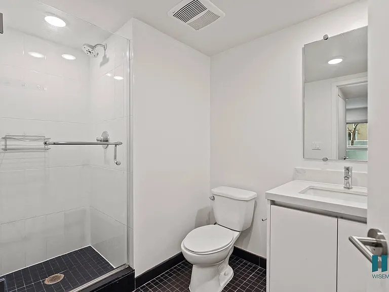 Bathroom with Stand-Up Shower with Glass Door and Vanity Cabinet Storage