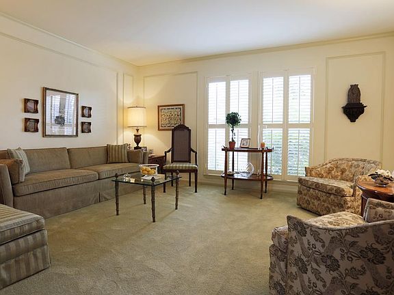 Living Room, 12' x 15', is bright and sunny with recent plantation shutters, windows and paint.