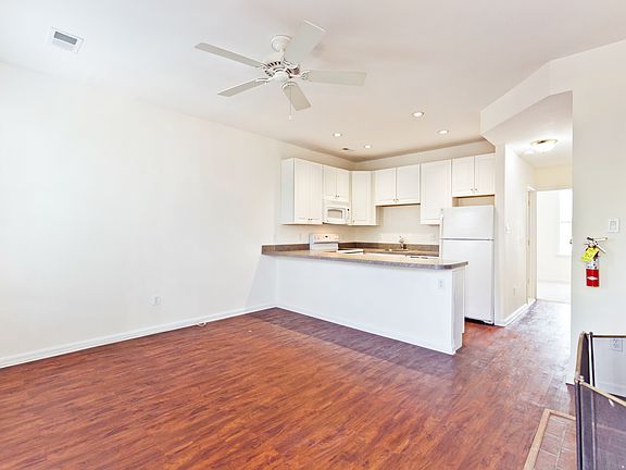 Living room looking towards kitchen and hallway to bathroom and bedroom