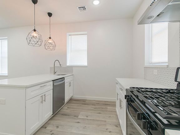 the large kitchen island offers great storage with spacious cabinets and drawers and tons of clear counter space with multiple convenient outlets. It hosts the dishwasher and a deep kitchen sink with pull out sprayer.