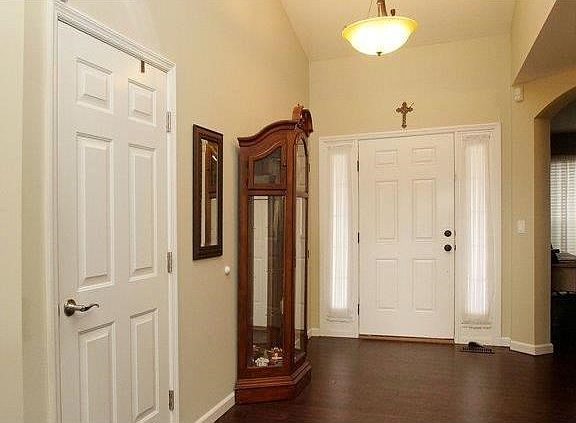 Vaulted foyer with wood floor