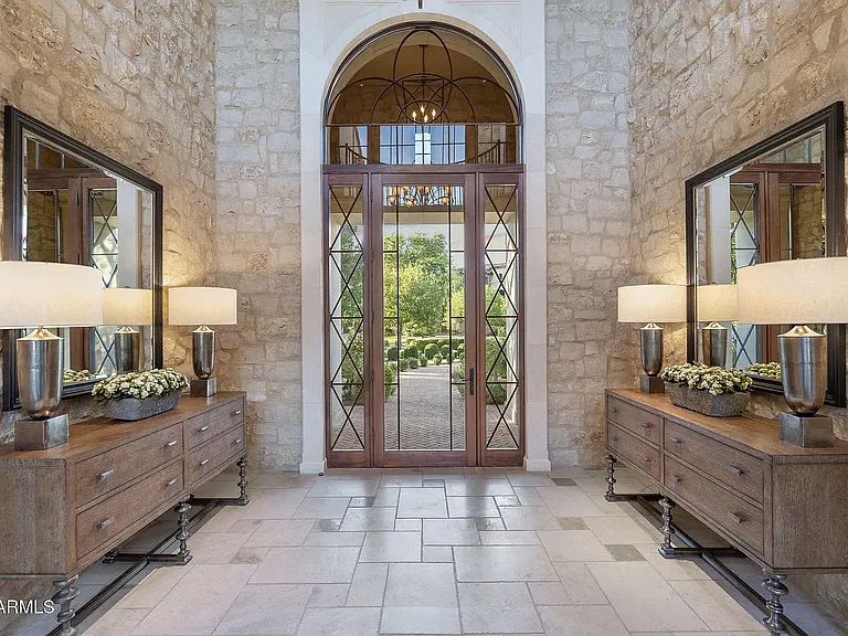 Stunning entryway showcasing natural stone walls, grand double doors, and a light_filled, welcoming design.
