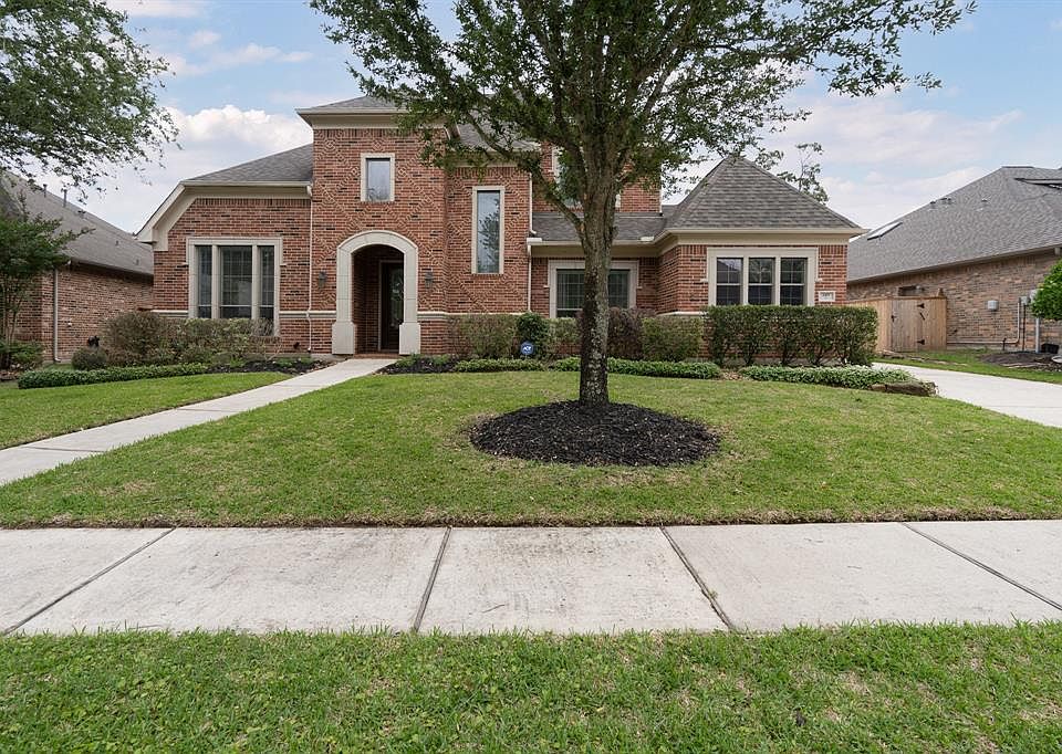 Beautiful 2-story Darling home nestled on a lake front lot in the desirable gated neighborhood of Lakes of Cypress Forest!