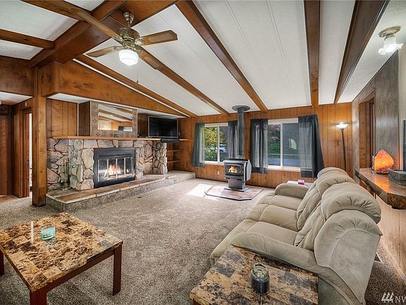 Carpet in living room only a couple years old with free standing wood stove and stone fireplace.  Room is very spacious.