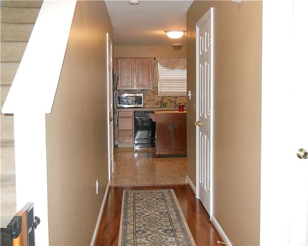 Foyer with hardwood floors and closet
