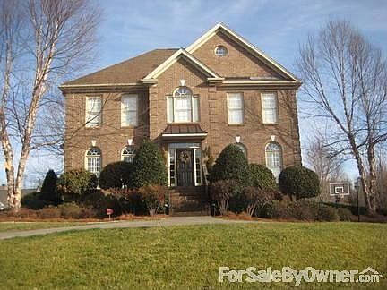 Professionally landscaped yard with landscape lights