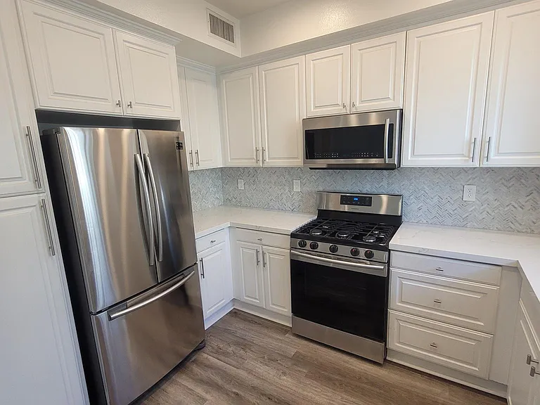 Well cared for stove and microwave, and 1-year new refrigerator (newer than photo).