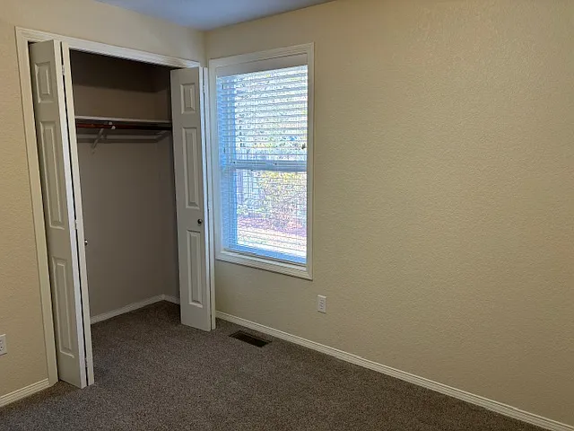 Bedroom #1 with view of back patio