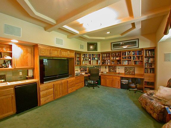 Main level den/office features a Murphy bed