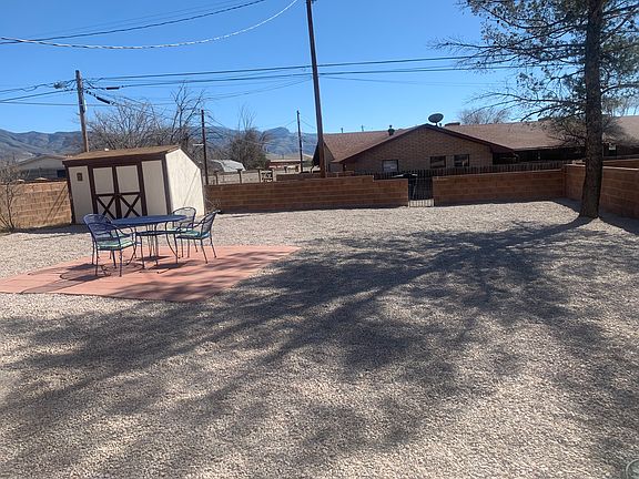 Large backyard with pavers and storage shed