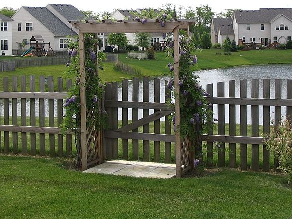 Fully fenced yard overlooking pond