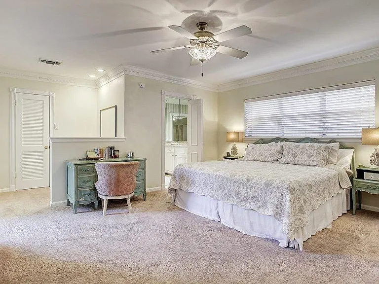 Huge master bedroom with his and hers closets and a make up or desk area.