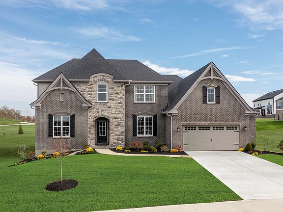 custom home with stone and brick exterior