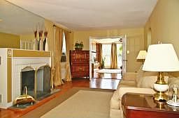 Living room w/wood burning fireplace w/french doors leading to family room 