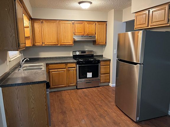 kitchen with new stainless steel appliances, Fridge, gas stove, and dishwasher