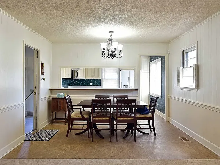dining room with kitchen and garage door entry