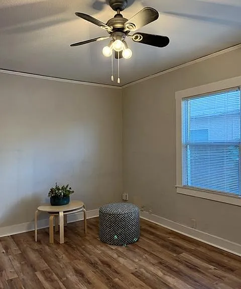 Living space opens to another room that could be used for dining or an office. Wood laminate flooring, ceiling fan, two tone paint, picture molding.