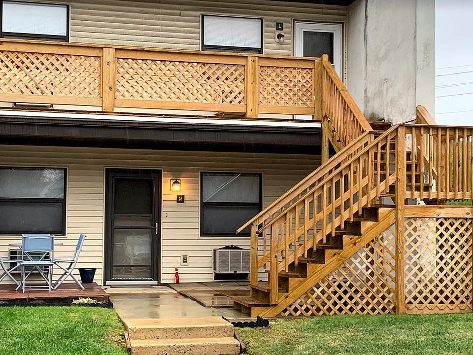 First floor (all one-floor living) with floating deck, cement patio, and common lawn area and 1 car parking under the light in front of the condo. All visitor parking spaces (4 additional spaces) next to the unit's assigned parking space. New siding.