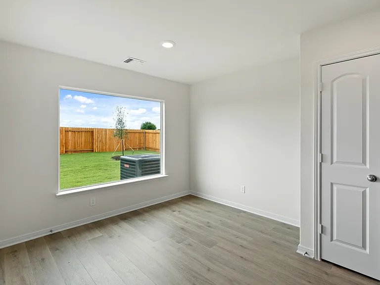 The dining room of sits right off of the kitchen and has a large window.