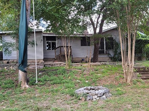 Back of house. Sits on a hill.