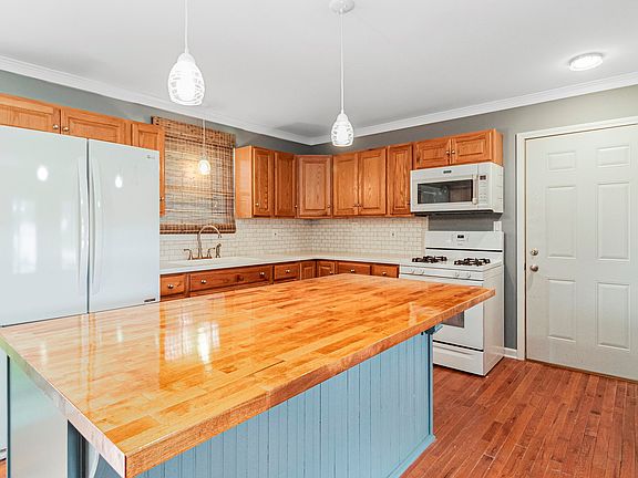 Much work has been done, including counters, backsplash, island, some light fixtures, paint, cabinet