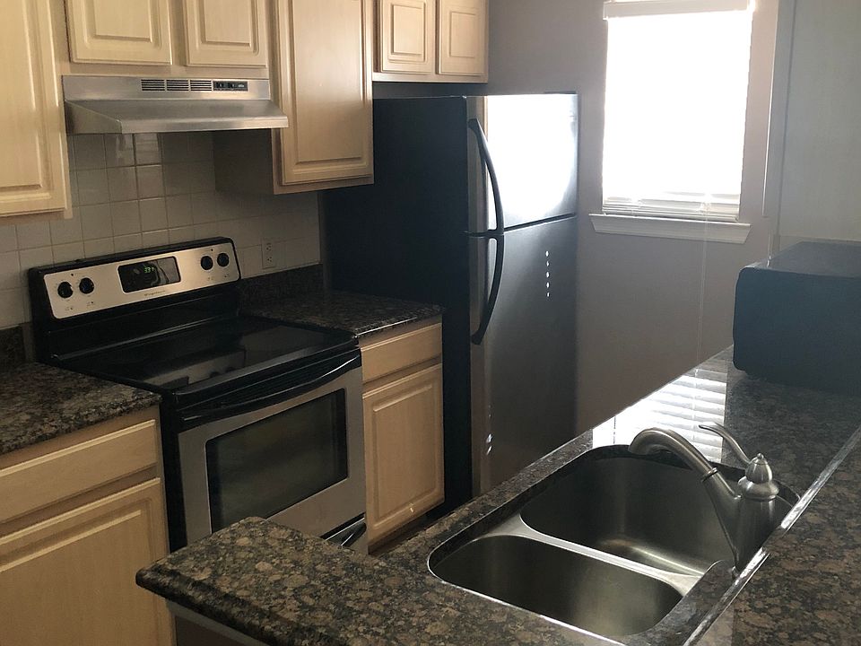The kitchen will have black cabinet hardware, black on black appliances, and light colored counter tops. (Pictured is a sample kitchen of the same floor plan. )