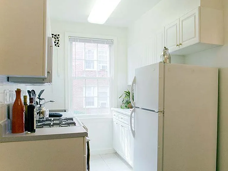 Kitchen with white cabinetry and appliances