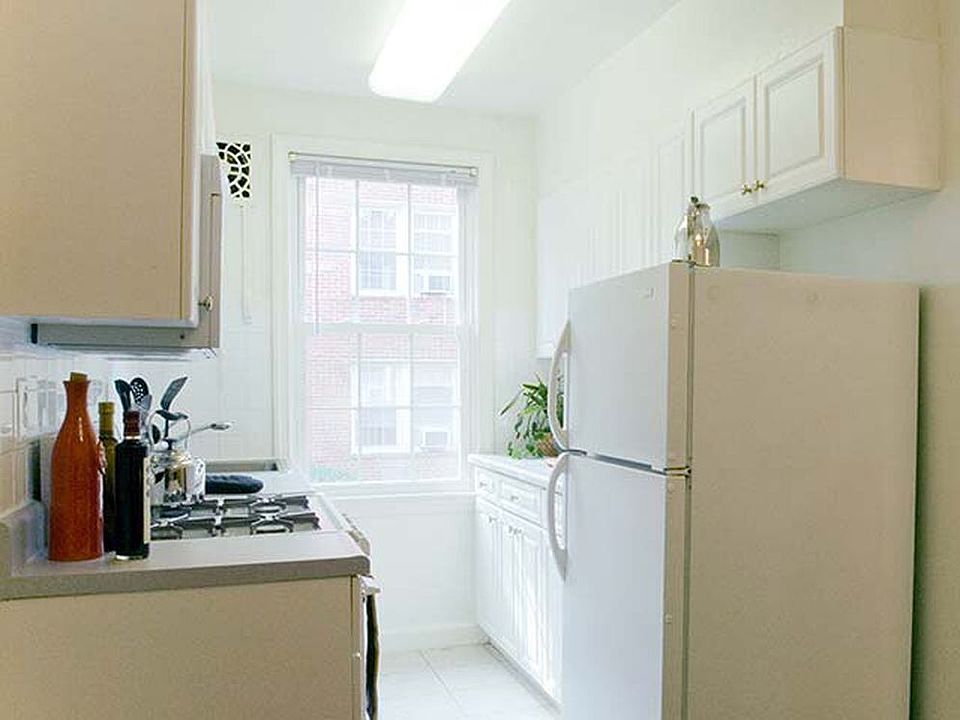 Kitchen with white cabinetry and appliances