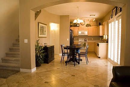 The view of the dining and kitchen from the family room. Notice the Travertine
