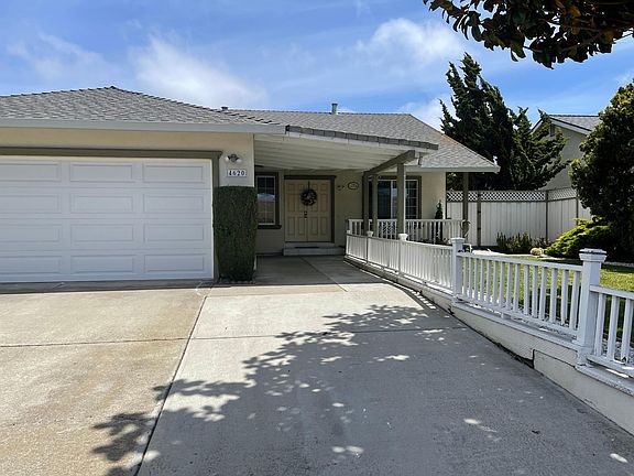 Garage, spacious driveway alongside the main entrance with motion sensor lights.