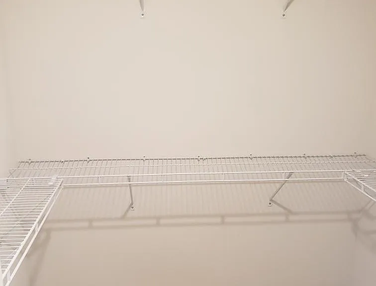 Huge master walk in closet with sliding pocket doors