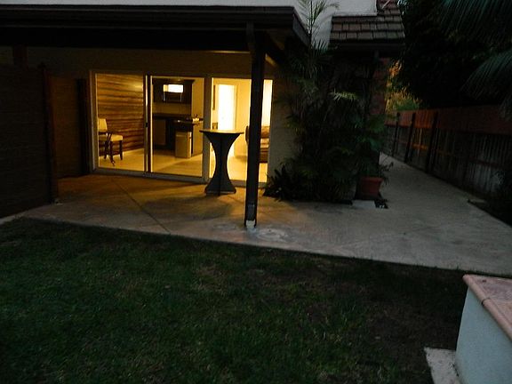 Private rear entry triple glass slider with back yard and covered patio. Side yard access room for outside covered storage and or bicycles. E