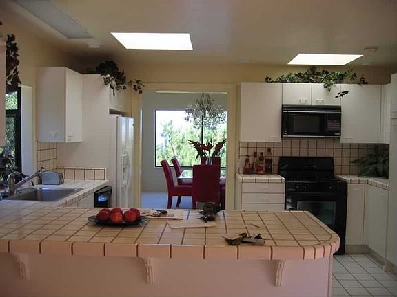 from family room, through kitchen looking out window of dining room.