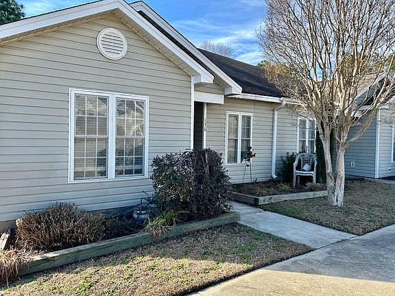 Front walk to door and flower beds.