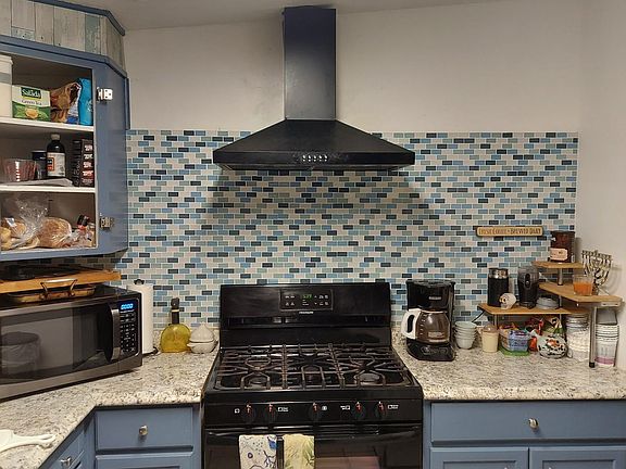 Kitchen. Missing cabinet doors will be repaired
