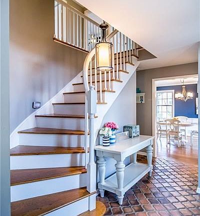 Beautiful curved staircase & Mediterranean tile beckon you inside