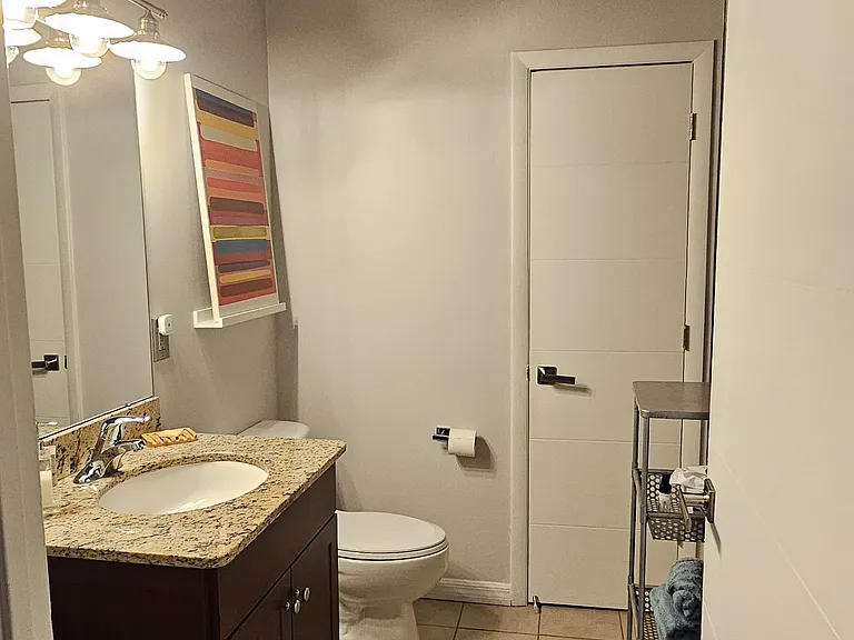 Downstairs' half bath includes large storage closet.