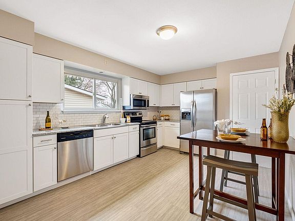Completely remodeled kitchen with stainless steel appliances, granite counter tops, new luxury vinyl flooring and new contempora