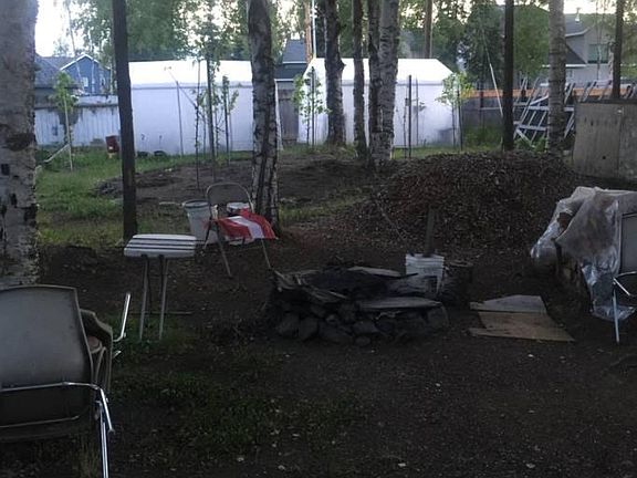 Large backyard with fire pit.