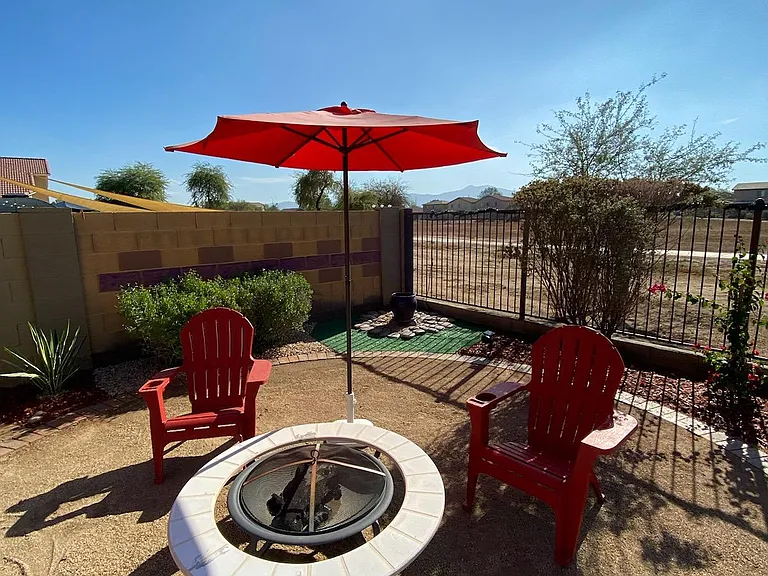 Beautifully landscaped backyard oasis featuring stunning Estrella Mountain and South Mountain views. Unwind and enjoy the backyard with family and friends. Picture taken November 17, 2023 early afternoon.