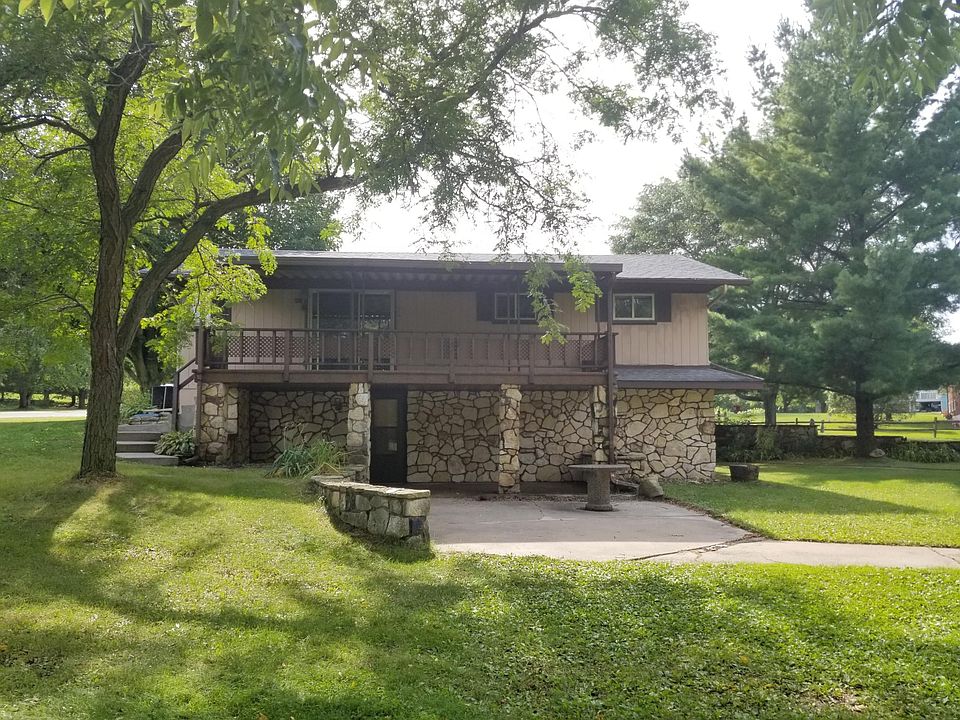 Photo from South Street (Cnty CS) showing lawn, patio and balcony.