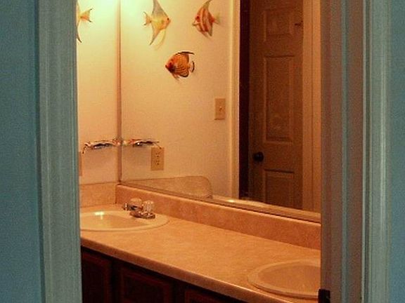 Full bath features a double vanity with a separate bath area for privacy.