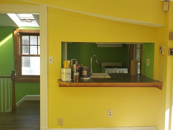 Living room looking into kitchen and foyer area. There is no refrigerator because a new one is coming shortly