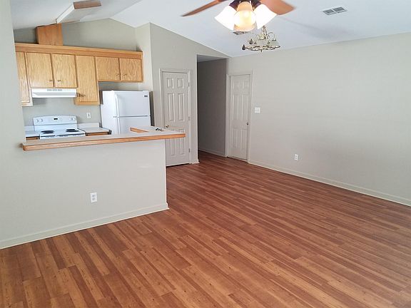 Living room with bar top and kitchen.