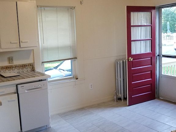 KITCHEN LEADING TO FRONT DOOR. NEW REFRIGERATOR NEW DISHWASHER