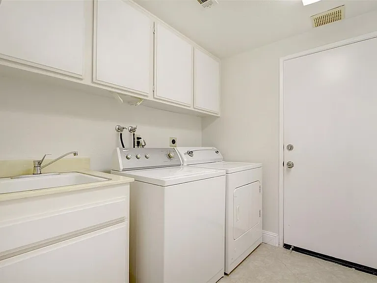 Laundry Room furtnished with washer dryer and laundry sink